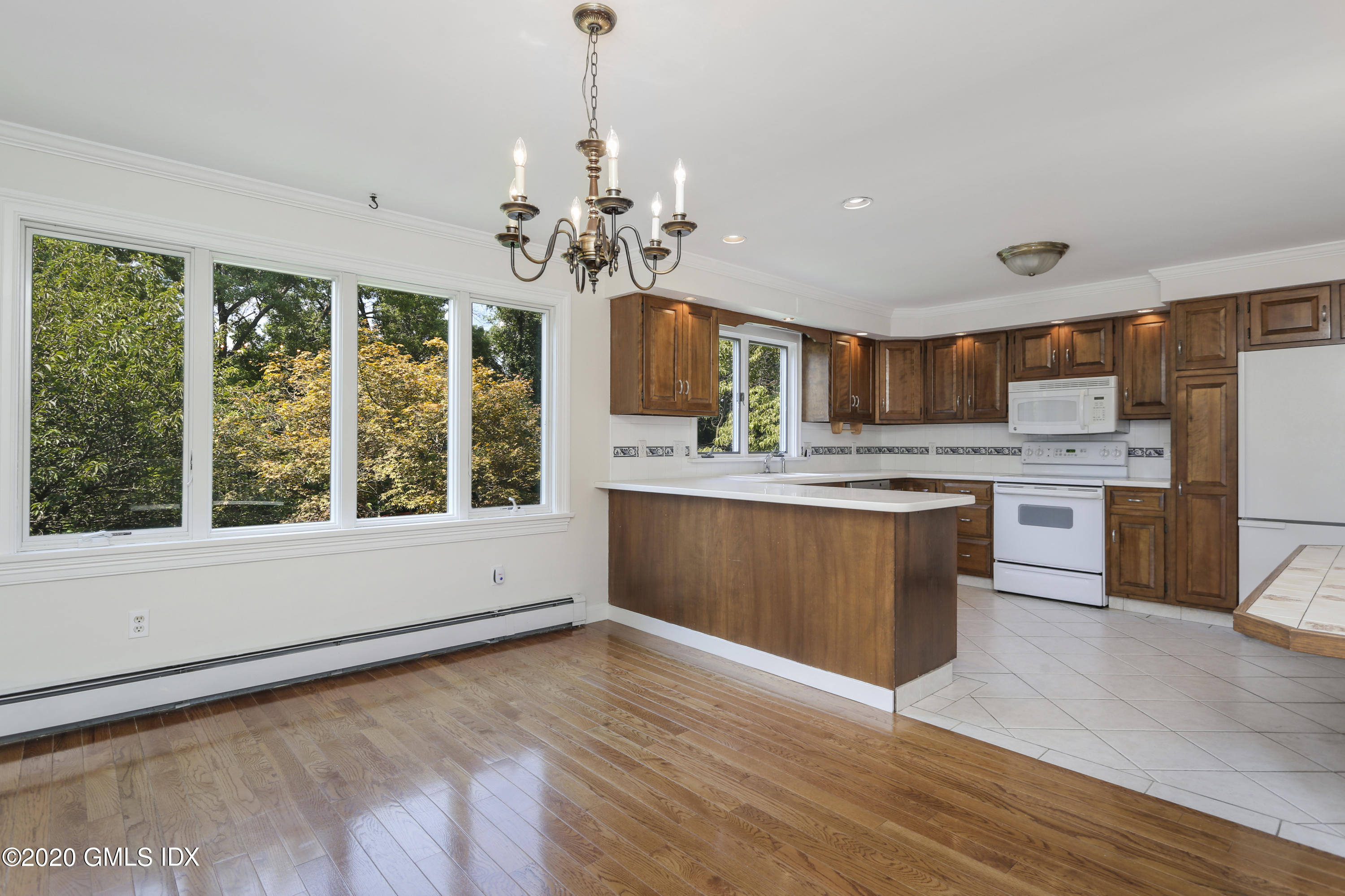 18 Norias Road Greenwich, CT 06830 - Photo 10 of 37 a large kitchen with stainless steel appliances granite countertop a stove and a wooden floors