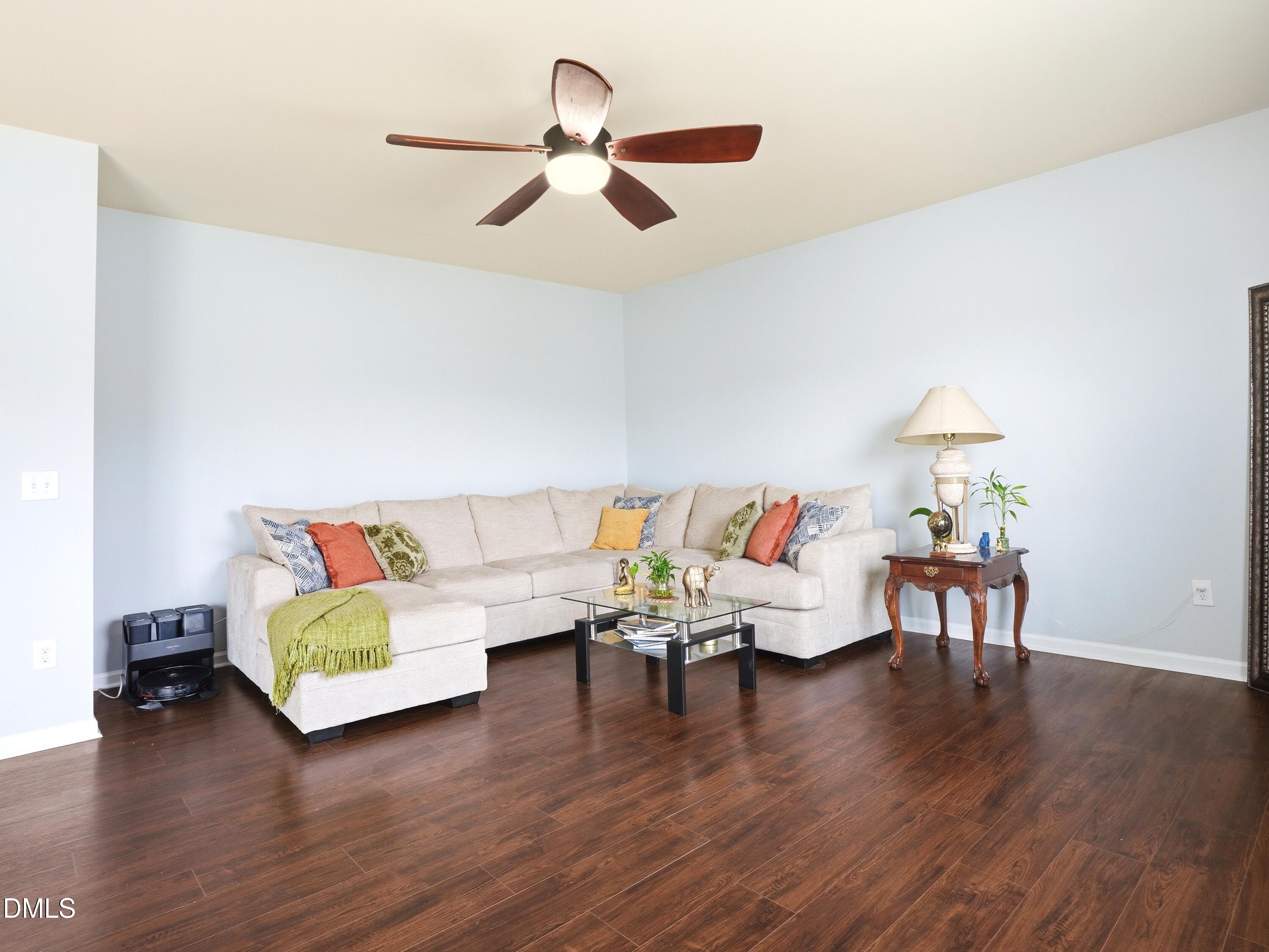 8128 Hovingham Way Raleigh, NC 27616 - Photo 13 of 40 a living room with furniture and a wooden floor