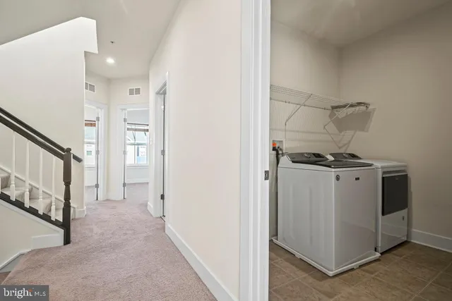 a view of hallway with washer and dryer