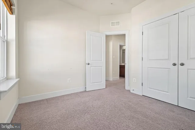 an empty room with closet area