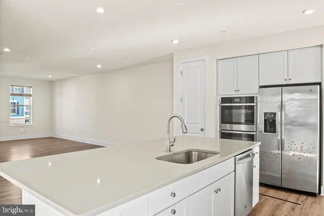a kitchen with stainless steel appliances a sink stove and refrigerator