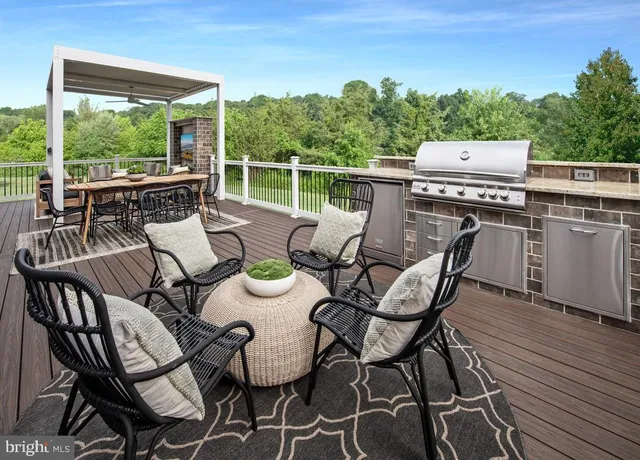 a view of a patio with chairs and table on the wooden floor