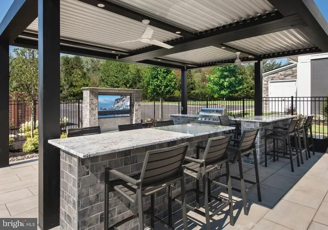 a view of a patio with table and chairs under an umbrella
