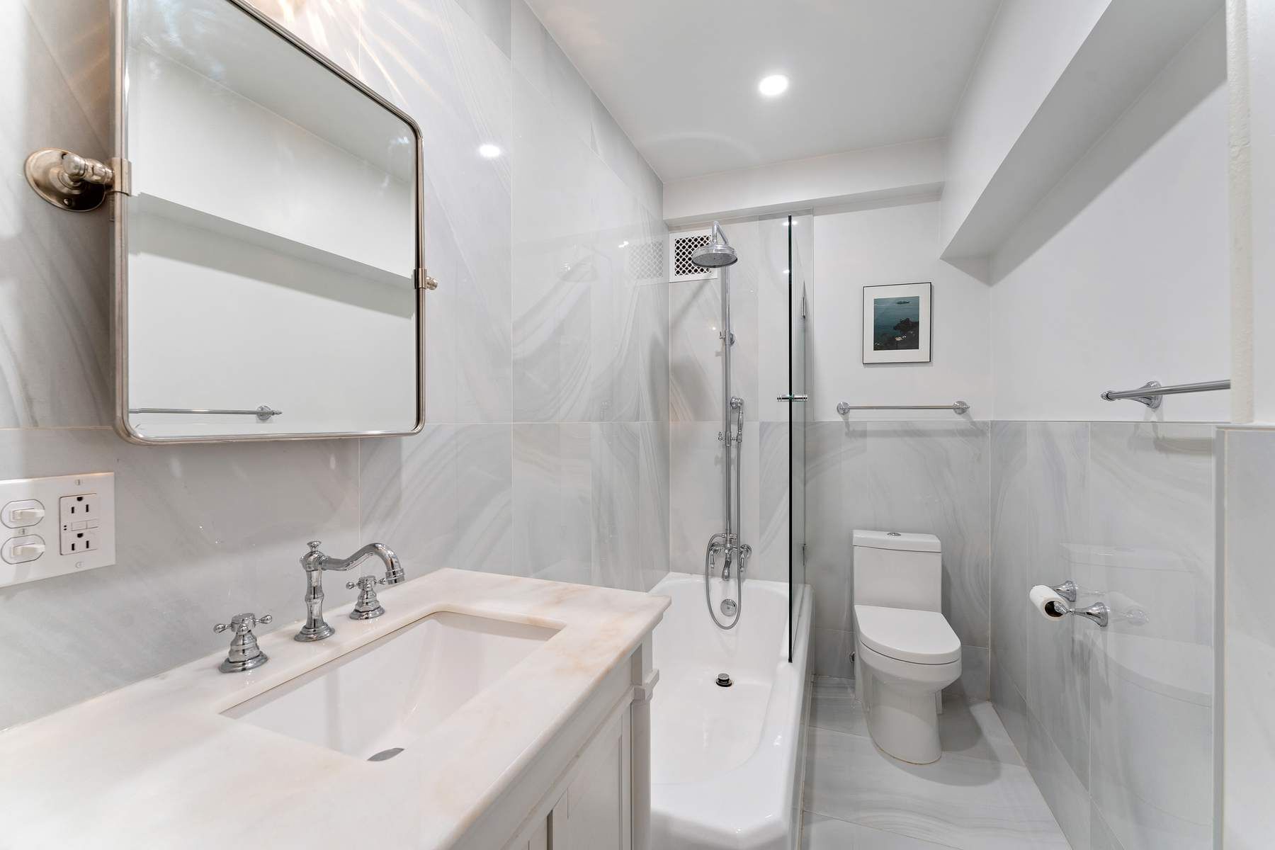 10 Park Avenue, Unit 10R Manhattan, NY 10016 - Photo 6 of 9 a bathroom with a double vanity sink toilet mirror and shower