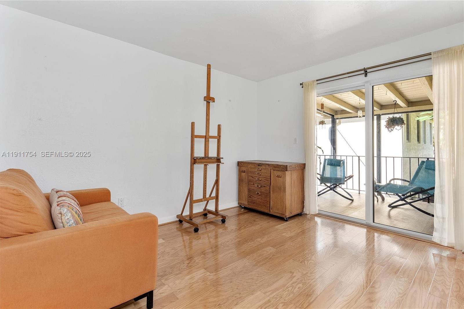3235 McDonald Street, Unit 5 Miami, FL 33133 - Photo 16 of 35 a living room with furniture and a floor to ceiling window