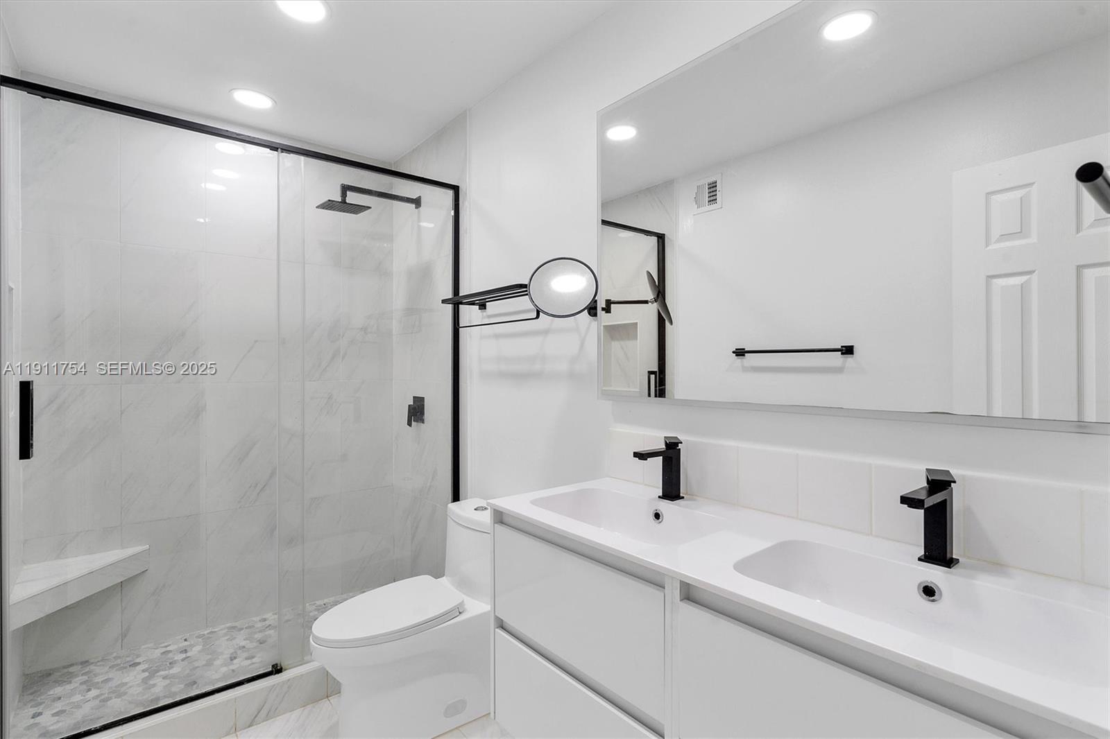 3235 McDonald Street, Unit 5 Miami, FL 33133 - Photo 17 of 35 a bathroom with a sink toilet and shower