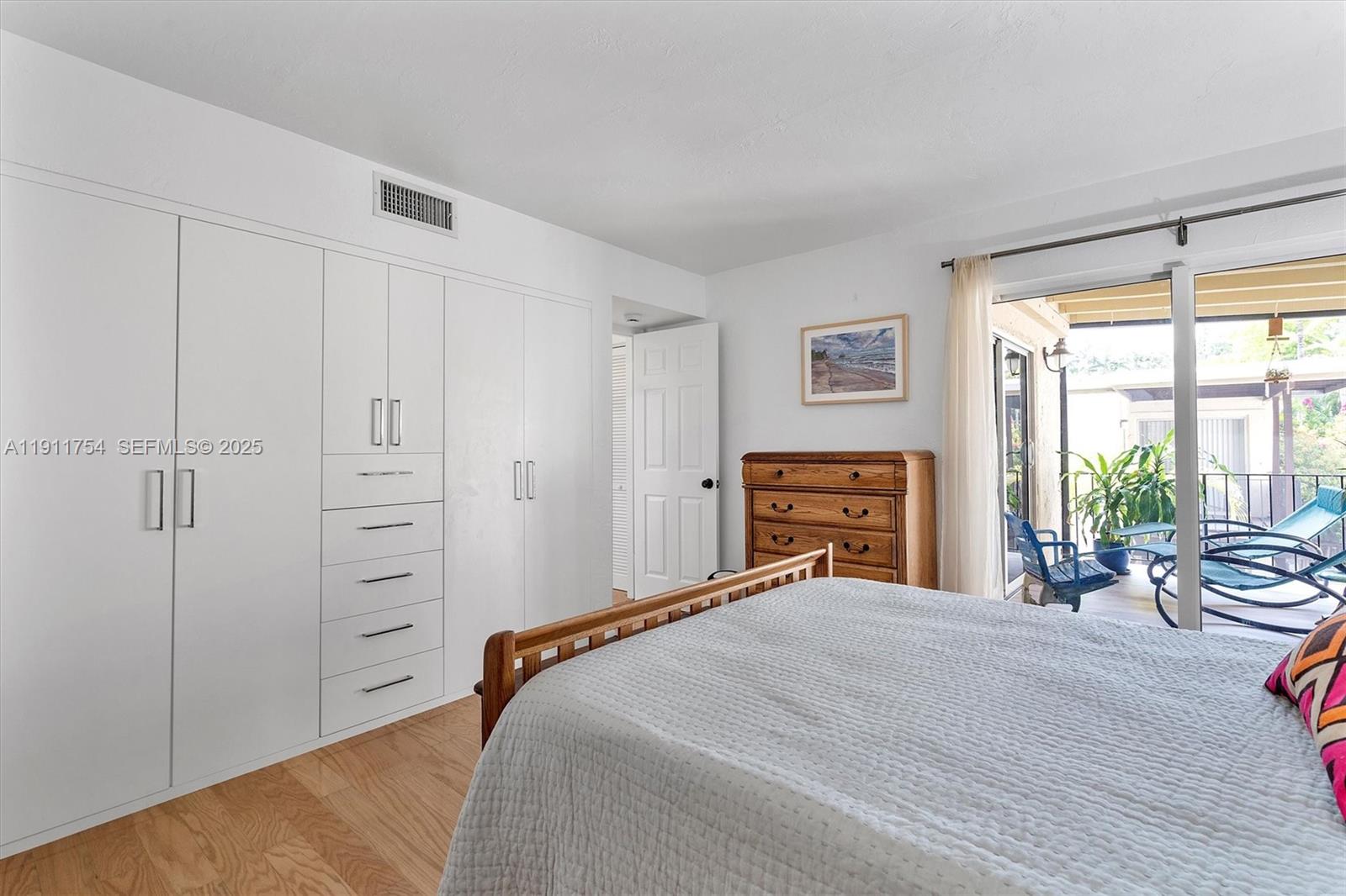 3235 McDonald Street, Unit 5 Miami, FL 33133 - Photo 18 of 35 a bedroom with a bed and a large window