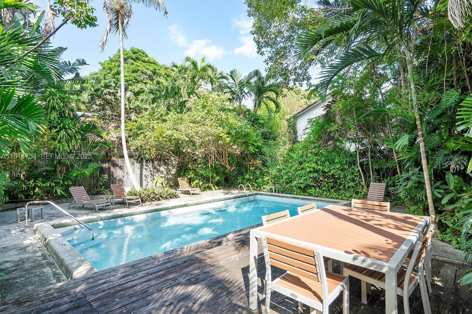 3235 McDonald Street, Unit 5 Miami, FL 33133 - Photo 33 of 35 a patio with water view and trees