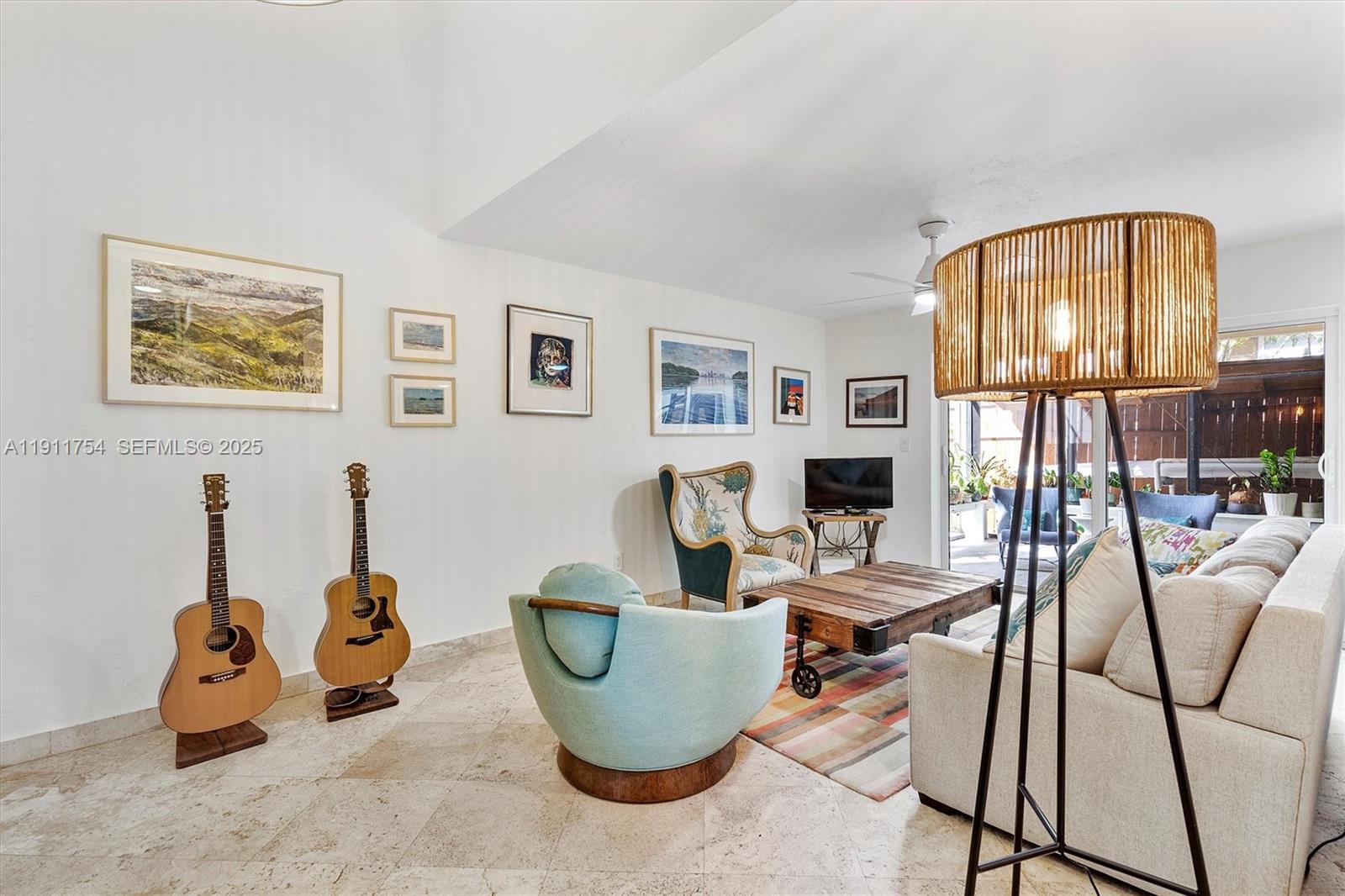 3235 McDonald Street, Unit 5 Miami, FL 33133 - Photo 4 of 35 a living room with furniture a flat screen tv and a large window
