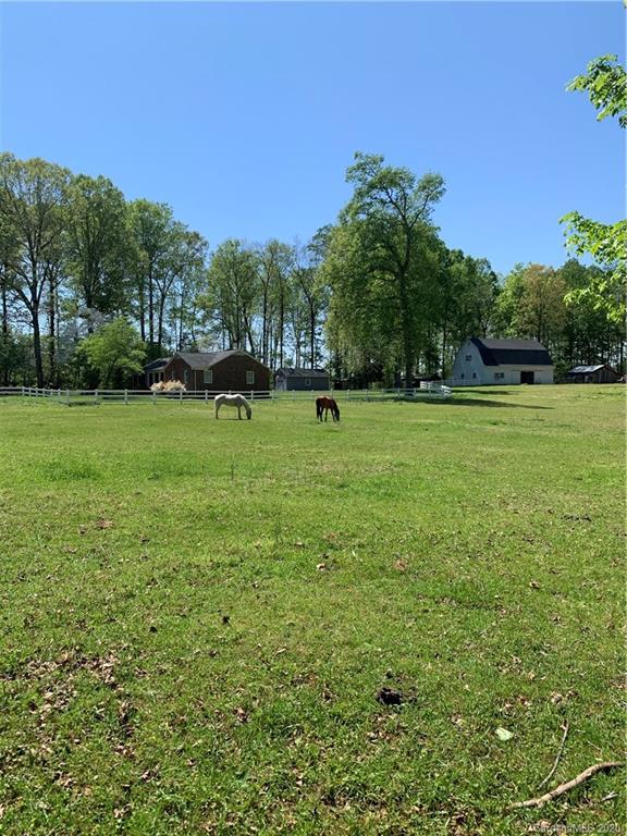 15015 Ranson Road Huntersville, NC 28078 - Photo 12 of 19 a view of a green field with trees in the background