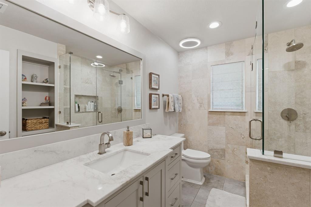 10390 Ridgecrest Street Frisco, TX 75033 - Photo 29 of 40 a bathroom with a sink a toilet and shower