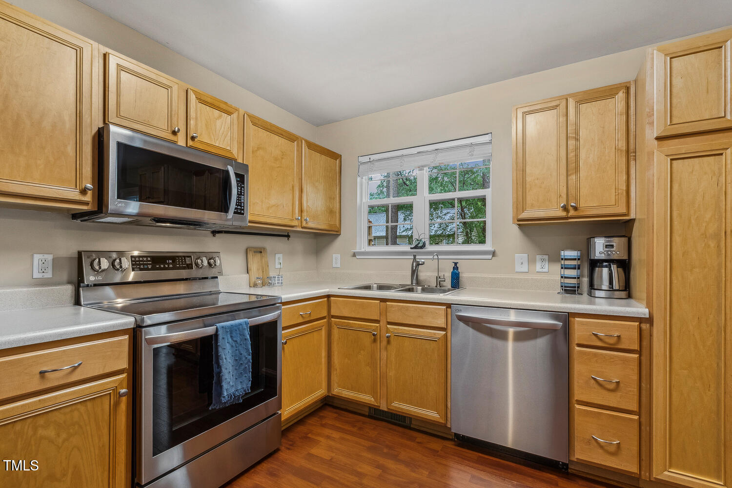 1984 Sadler Avenue Creedmoor, NC 27522 - Photo 19 of 44 a kitchen with cabinets stainless steel appliances a sink and a window