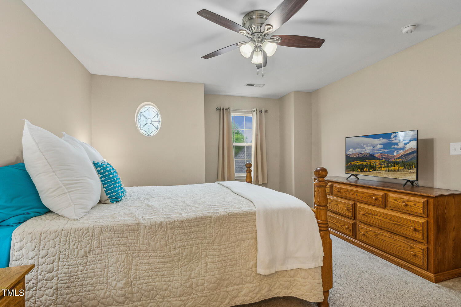 1984 Sadler Avenue Creedmoor, NC 27522 - Photo 25 of 44 a bedroom with a bed and a chandelier