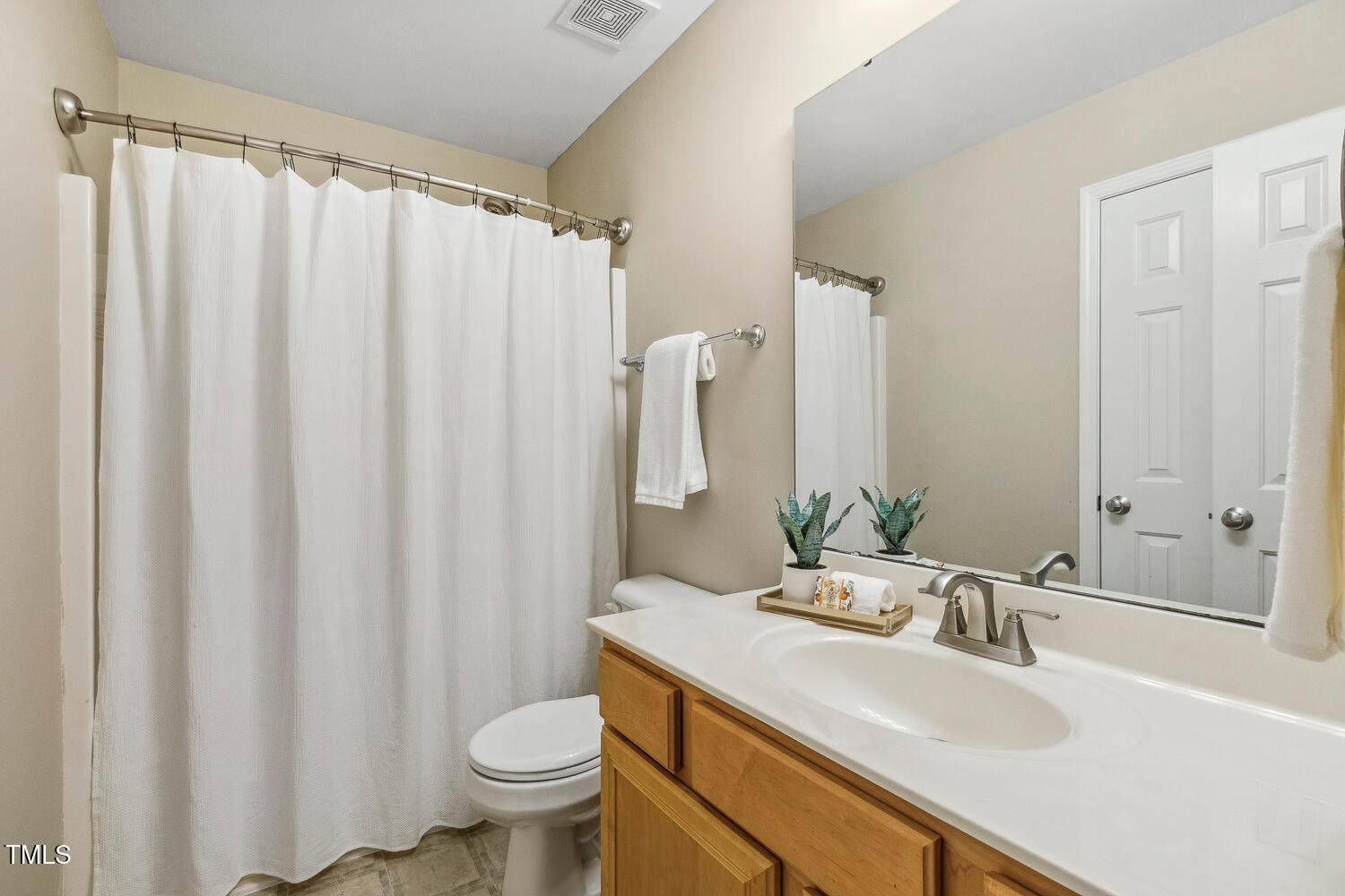1984 Sadler Avenue Creedmoor, NC 27522 - Photo 29 of 44 a bathroom with a sink a toilet and a mirror