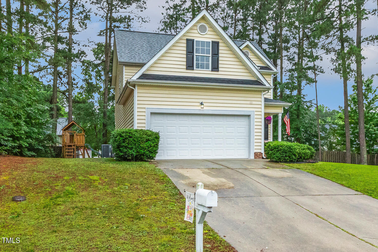1984 Sadler Avenue Creedmoor, NC 27522 - Photo 43 of 44 a front view of a house with a yard and garage