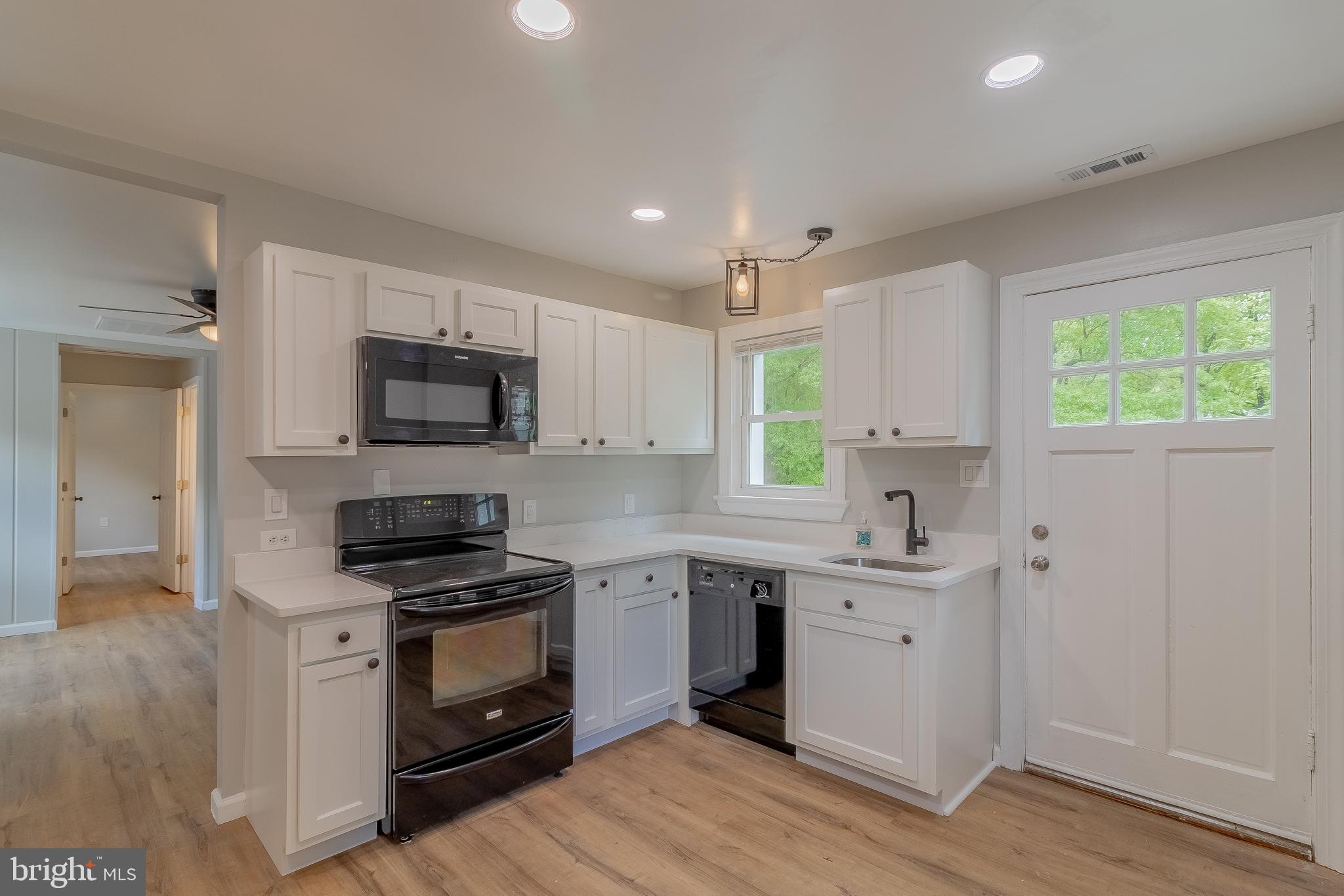 1816 Maple Lane Accokeek, MD 20607 - Photo 1 of 24 a kitchen with white cabinets stainless steel appliances and sink