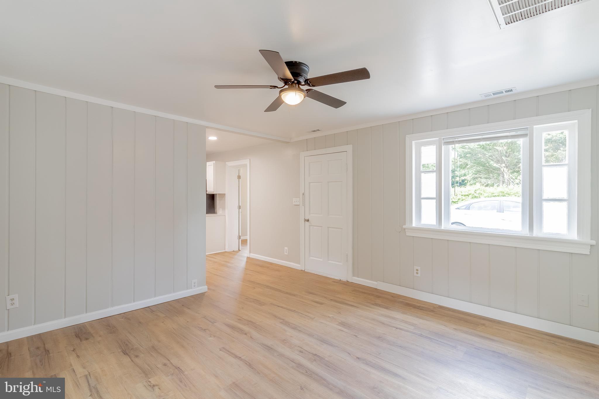 1816 Maple Lane Accokeek, MD 20607 - Photo 12 of 24 a view of an empty room with wooden floor and a window
