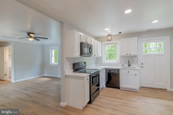 a kitchen with a stove top oven sink and cabinets