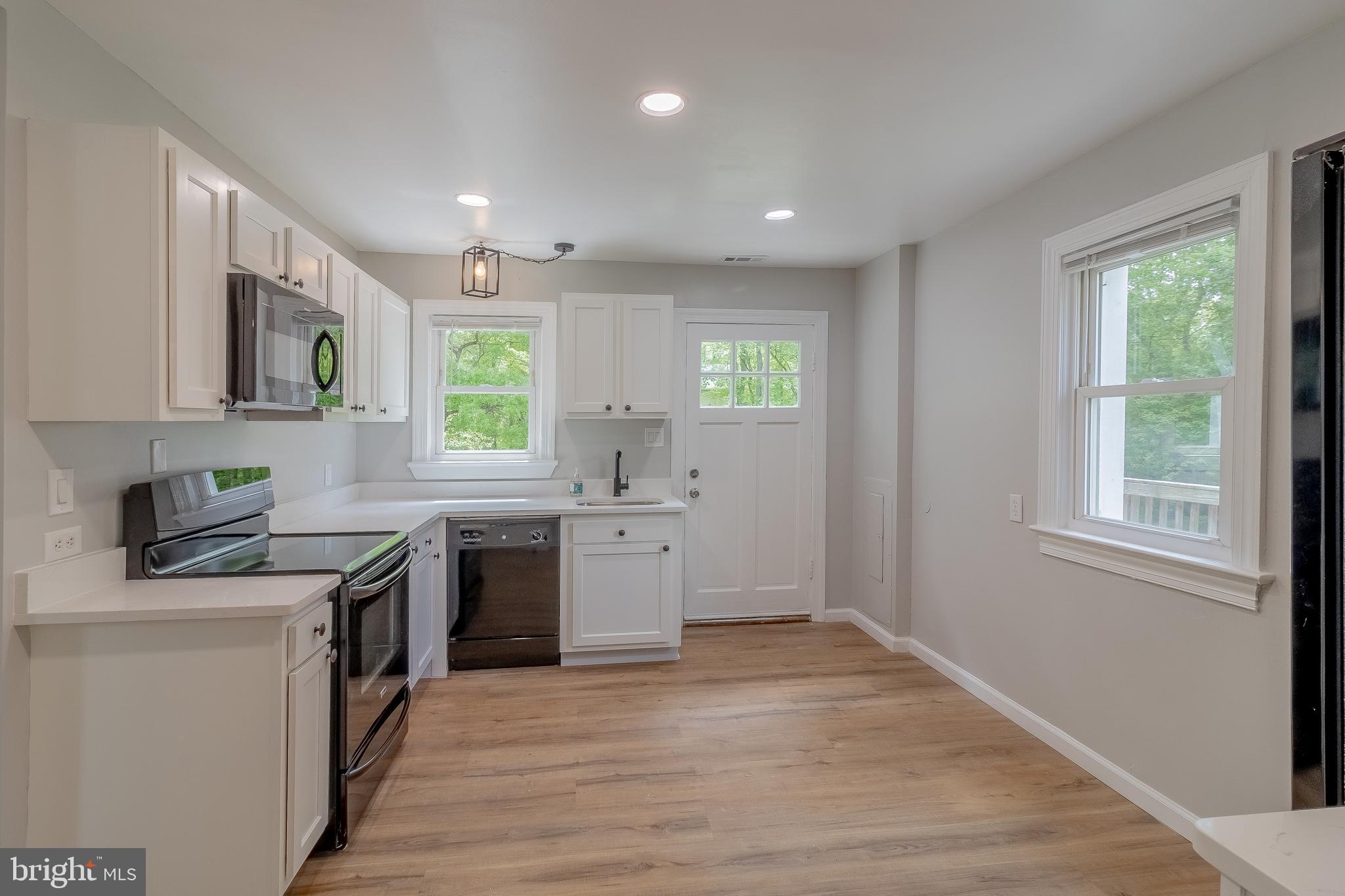 1816 Maple Lane Accokeek, MD 20607 - Photo 14 of 24 a kitchen with a sink cabinets appliances and a window