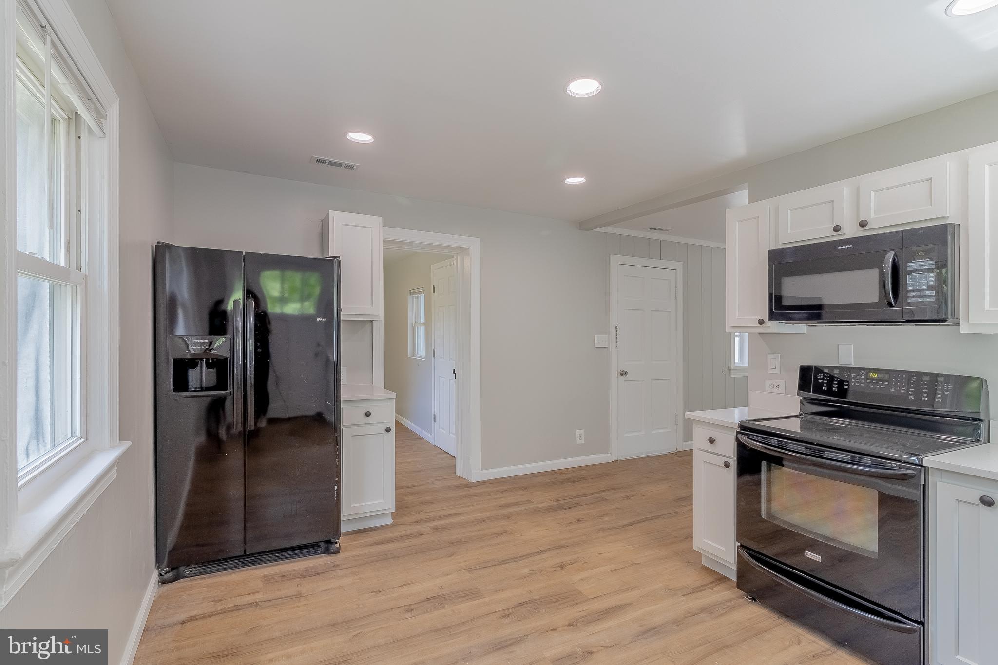 1816 Maple Lane Accokeek, MD 20607 - Photo 17 of 24 a kitchen with a refrigerator and a stove top oven