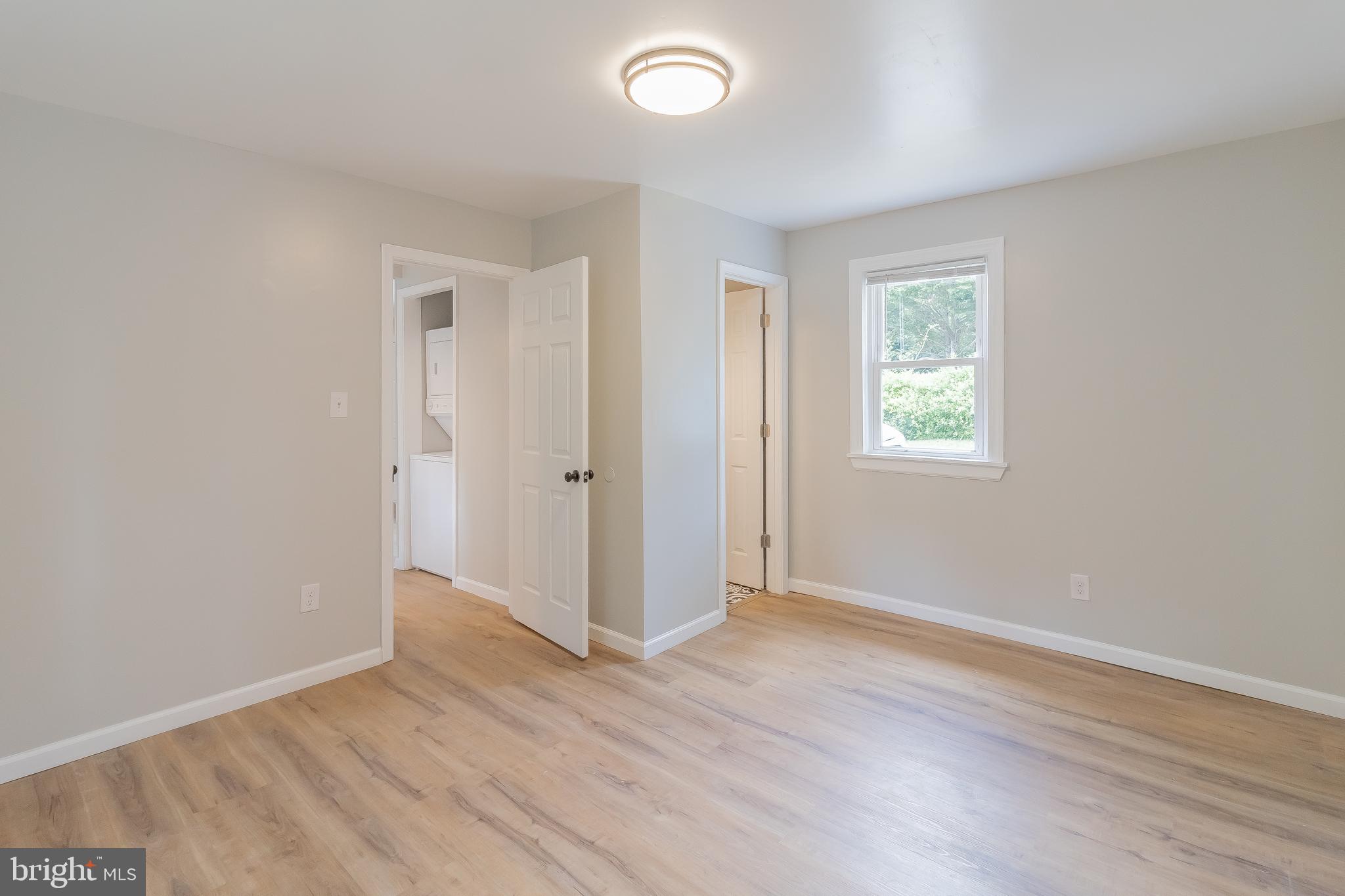 1816 Maple Lane Accokeek, MD 20607 - Photo 5 of 24 an empty room with wooden floor and windows
