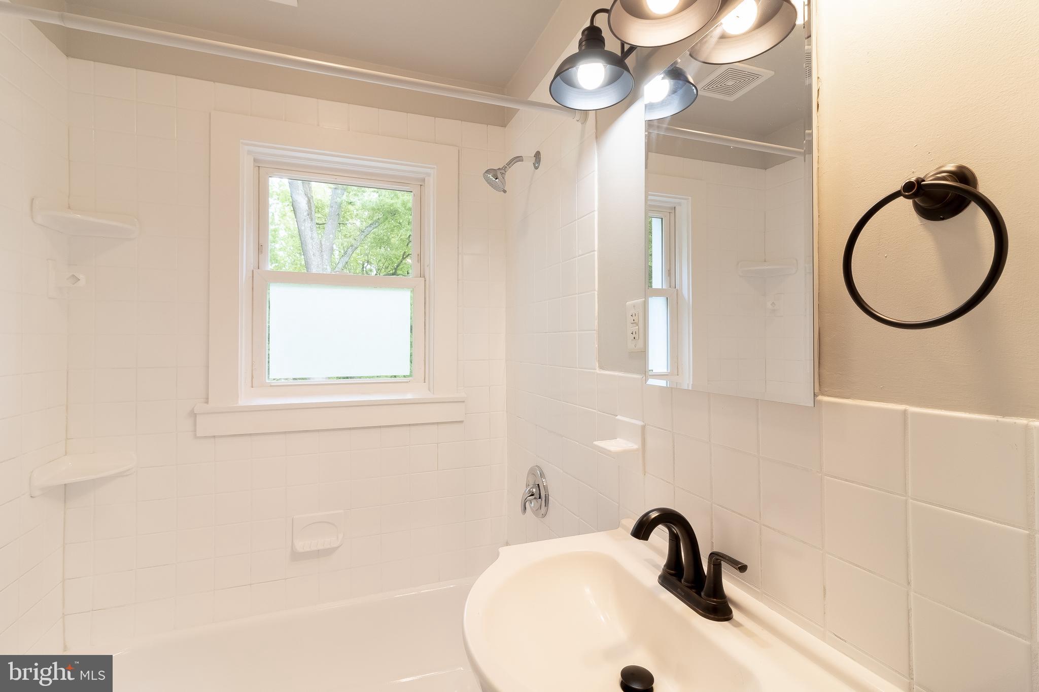 1816 Maple Lane Accokeek, MD 20607 - Photo 8 of 24 a bathroom with a sink and a mirror
