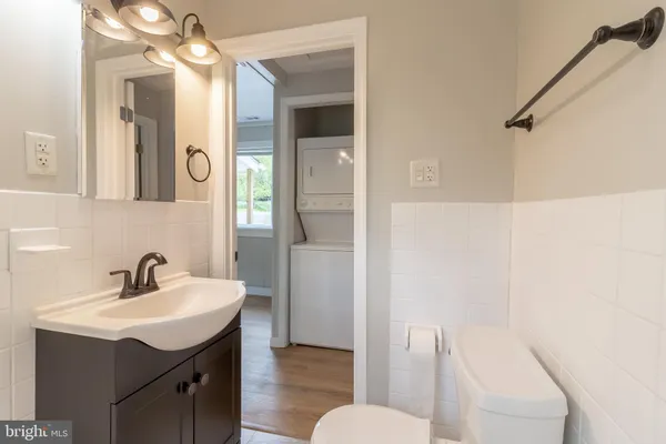 a bathroom with a sink a toilet and a mirror