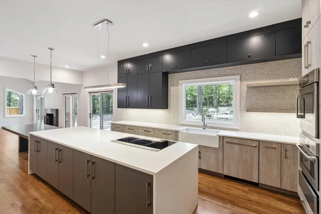 a kitchen with a sink stove and cabinets