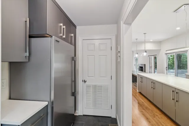 a kitchen with cabinets and a refrigerator