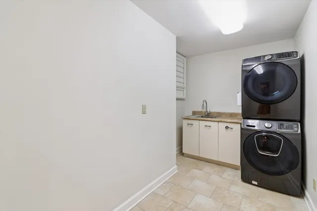a utility room with sink dryer and washer