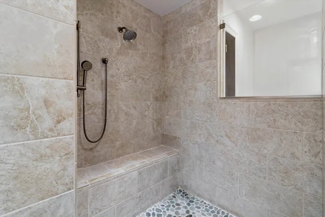 a bathroom with a glass shower door