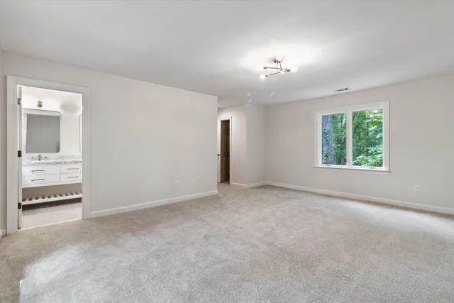 an empty room with a empty space and windows