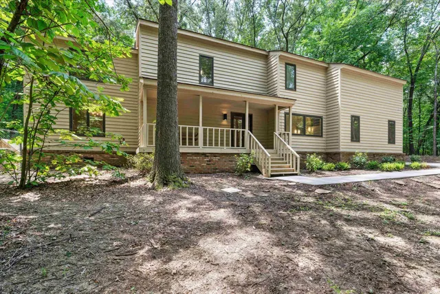 a front view of a house with garden