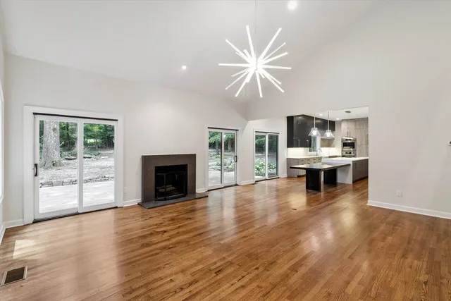 a view of an empty room with a window and fireplace