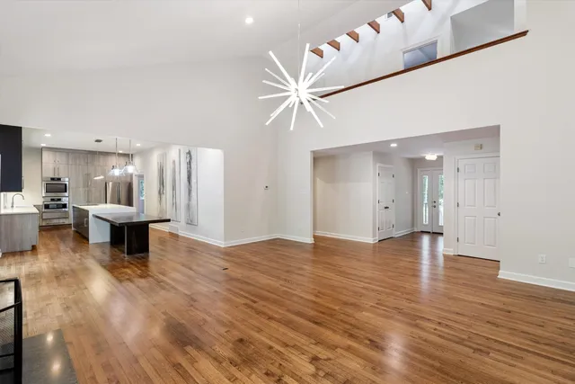 a view of a livingroom with a kitchen and a stove
