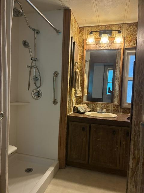 2150 Monterey Road, Unit 75 San Jose, CA 95112 - Photo 17 of 38 a bathroom with a granite countertop sink a mirror and shower