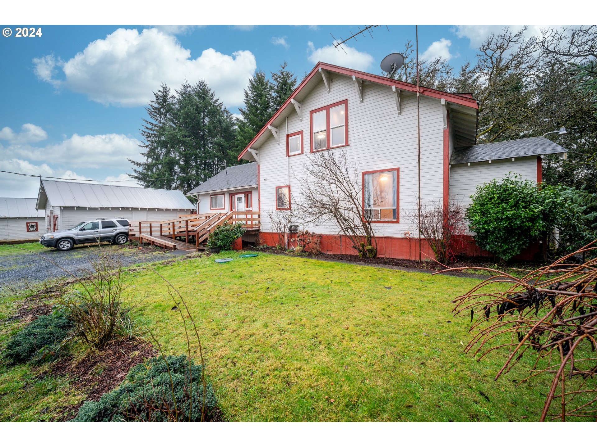 225 Nikula Road Winlock, WA 98596 - Photo 3 of 35 a view of a house with a big yard with potted plants and large tree
