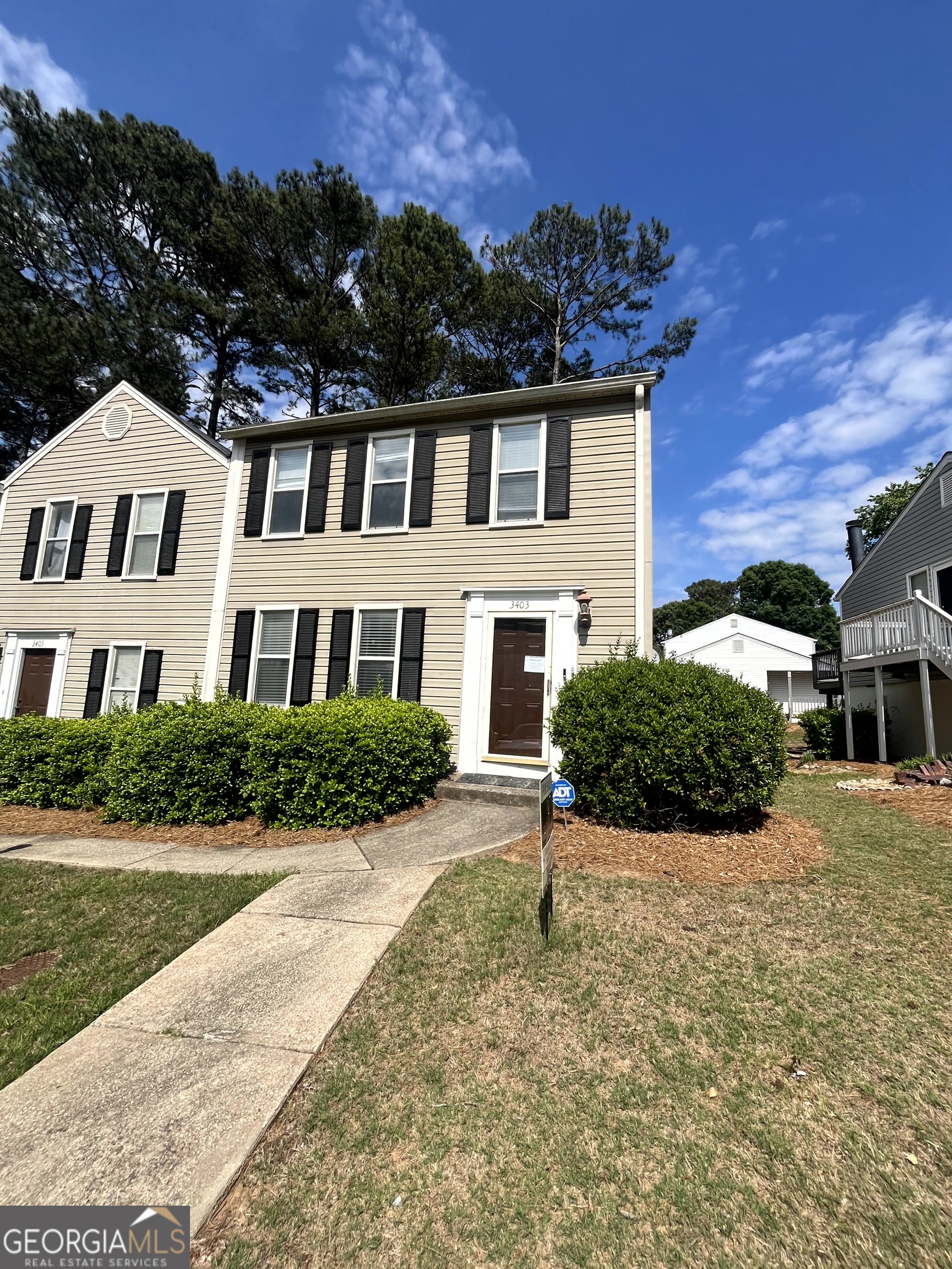 3403 Spring Harbour Drive Atlanta, GA 30340 - Photo 2 of 9 a front view of a house with a yard and outdoor seating