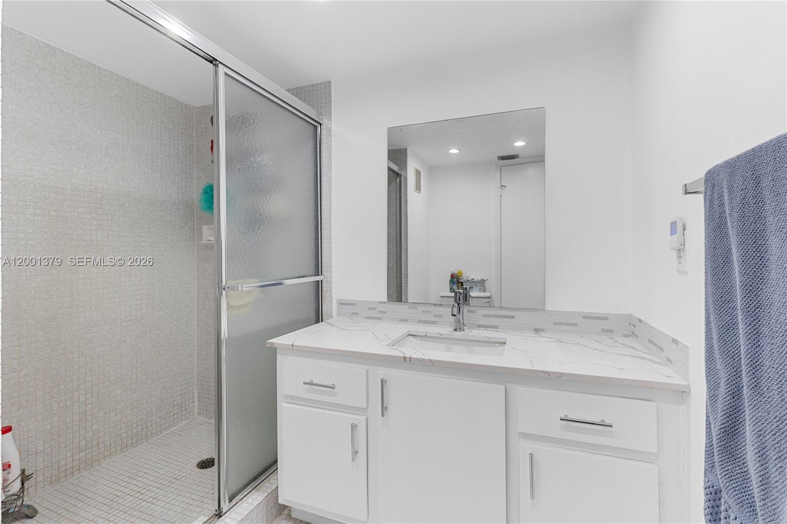 16251 Golf Club Road, Unit 311 Weston, FL 33326 - Photo 24 of 38 a bathroom with a granite countertop sink mirror and double