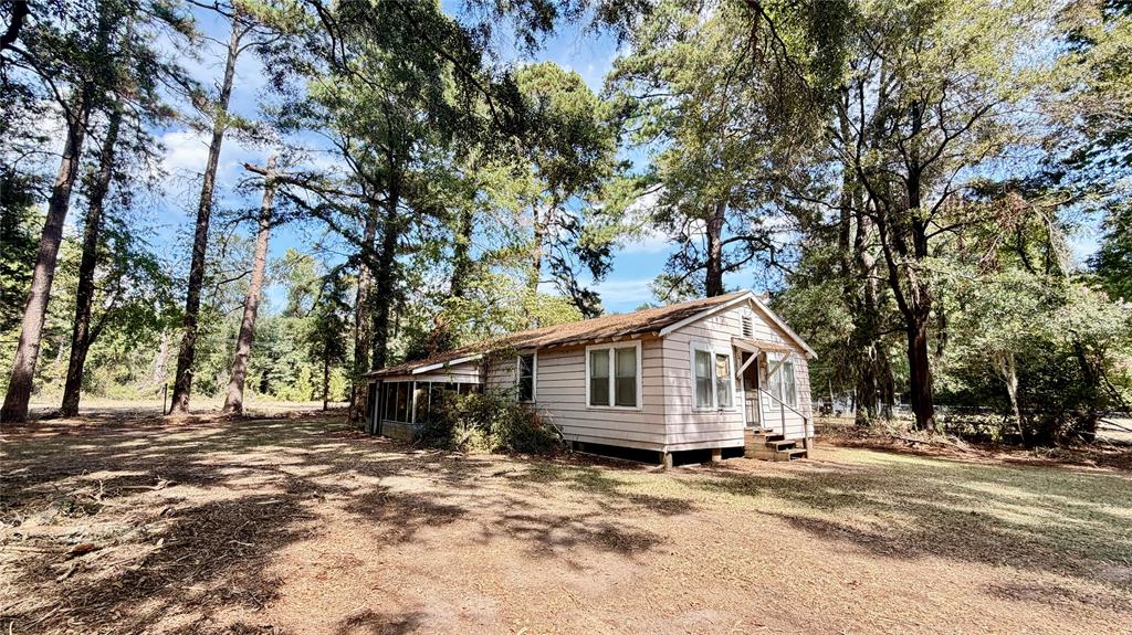 15585 Rudd Road Ida, LA 71044 - Photo 15 of 27 Single-story home featuring light-colored siding and a covered front porch with steps