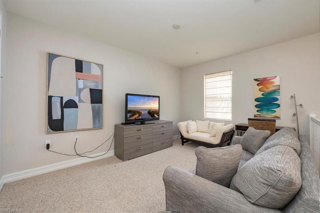 9105 Yuba Lane, Unit 7902 Naples, FL 34113 - Photo 14 of 25 a living room with furniture and a flat screen tv