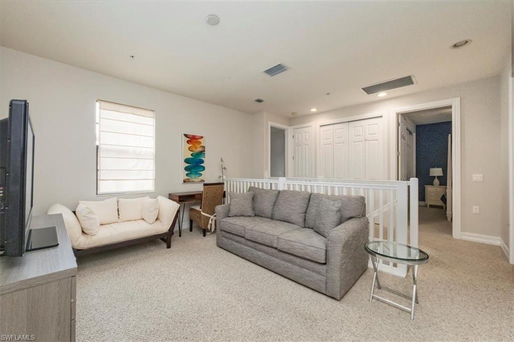 9105 Yuba Lane, Unit 7902 Naples, FL 34113 - Photo 15 of 25 a living room with furniture and a flat screen tv