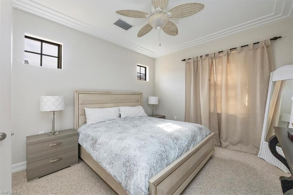 9105 Yuba Lane, Unit 7902 Naples, FL 34113 - Photo 16 of 25 a bedroom with a bed and a tv