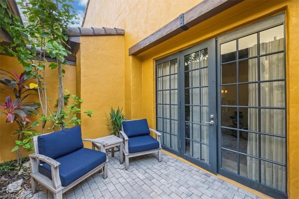 9105 Yuba Lane, Unit 7902 Naples, FL 34113 - Photo 24 of 25 a blue bench sitting in front of a building