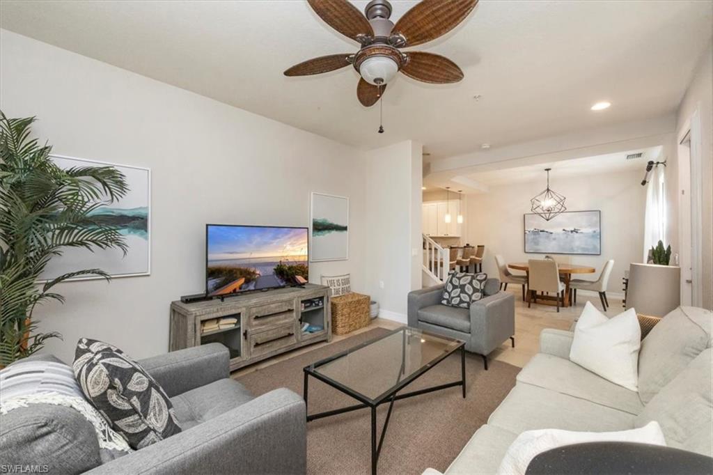 9105 Yuba Lane, Unit 7902 Naples, FL 34113 - Photo 3 of 25 a living room with furniture and a flat screen tv with potted plant