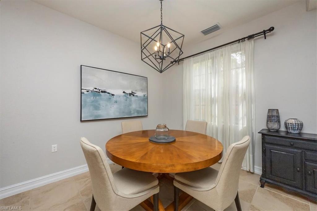 9105 Yuba Lane, Unit 7902 Naples, FL 34113 - Photo 8 of 25 a view of a dining room with furniture and window