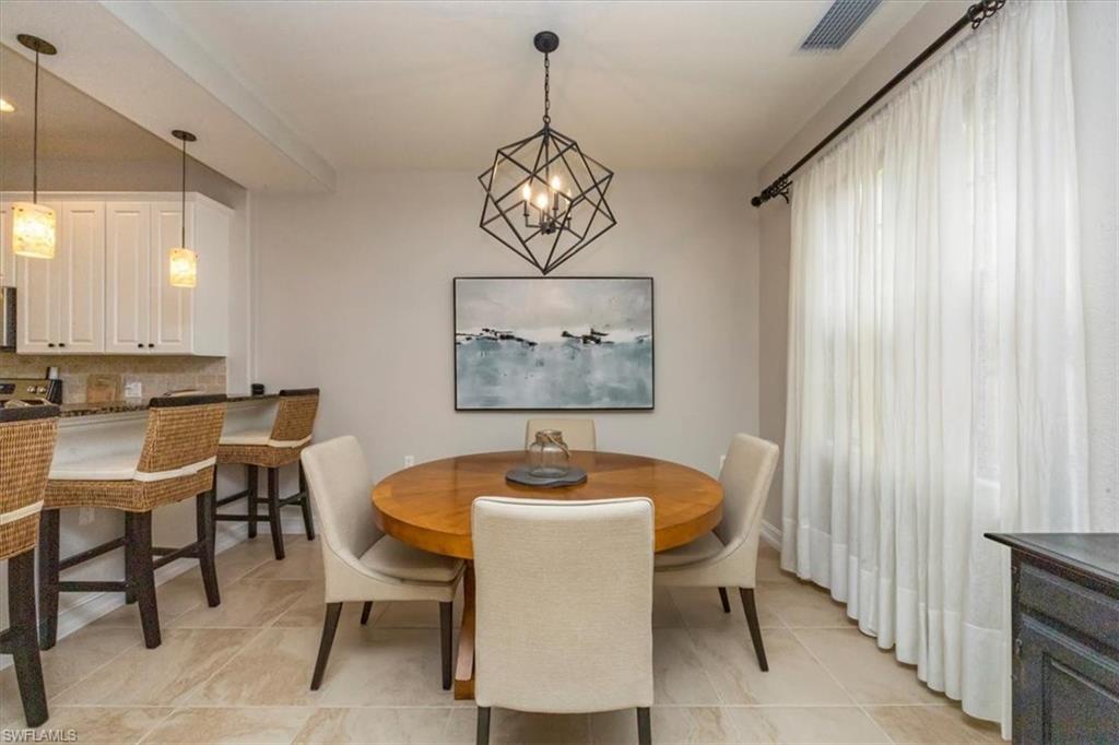 9105 Yuba Lane, Unit 7902 Naples, FL 34113 - Photo 9 of 25 a dining room with furniture and window