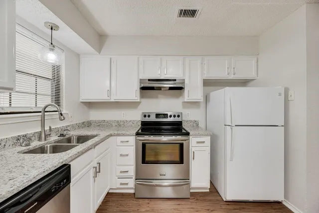 a kitchen with a stove and a refrigerator