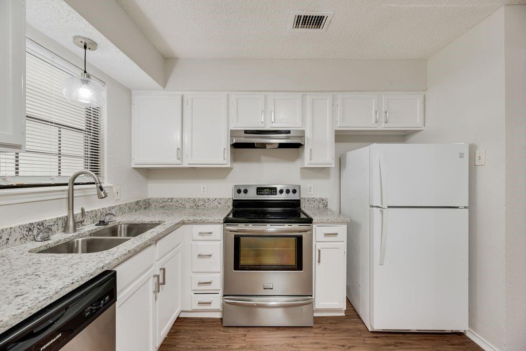 648 South Rogers Road, Unit 650 Irving, TX 75060 - Photo 11 of 21 a kitchen with a stove and a refrigerator