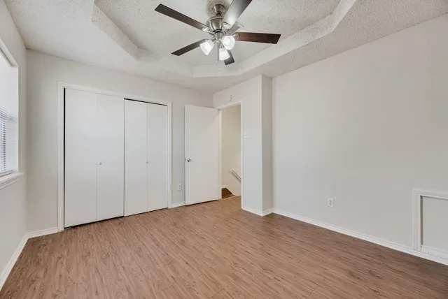a view of an empty room with wooden floor